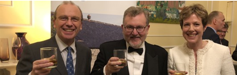people holding glass of whisky